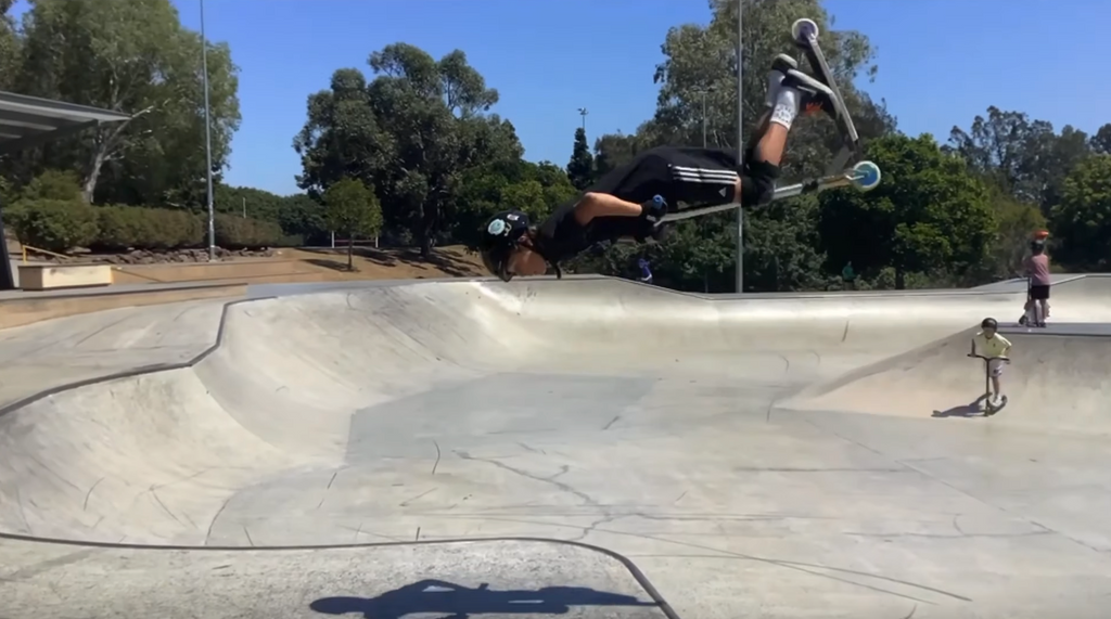 scooter rider Finn at the skatepark doing a backflip