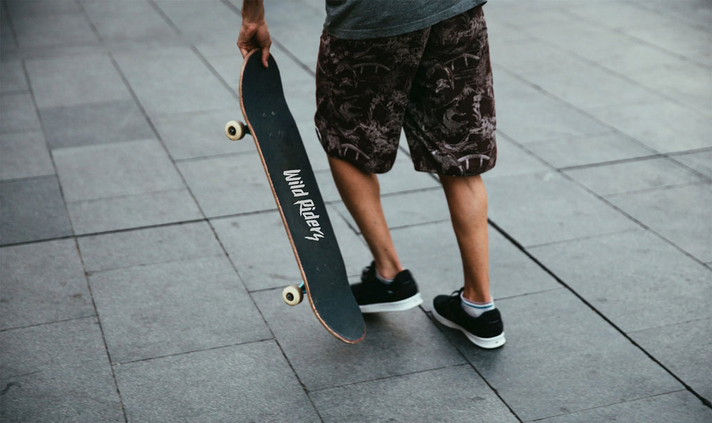 guy with a wild riders grip tape on his skateboard